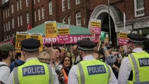 Asylum seekers could be moved from hotels into warehouses and other industrial or military sites under government plans to cut the spiralling cost of migrant accommodation.